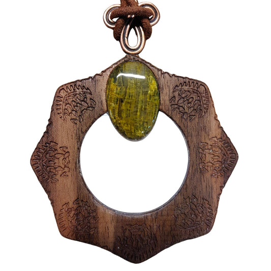 Magnifying glass necklace with nelite stone, mandala design, and adjustable leather cord.